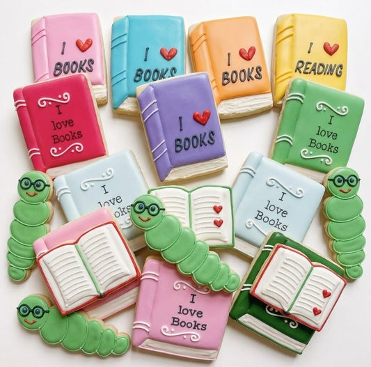 A 12-piece set of hand-decorated custom sugar cookies shaped like colorful books and open novels, arranged for National Read a Book Day