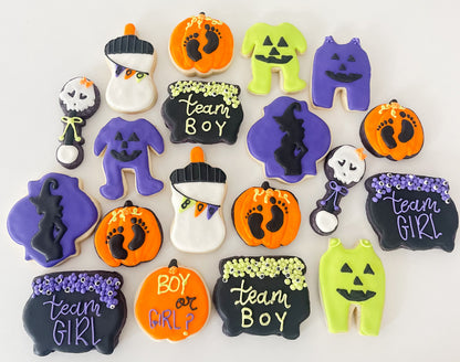 Handcrafted Halloween gender reveal cookies for a spooky baby shower celebration