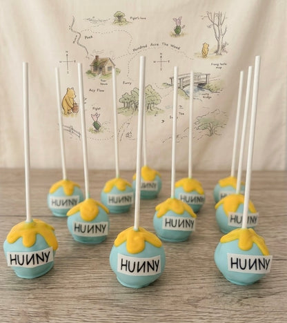 Handcrafted Winnie the Pooh cake pops and cake popsicles individually wrapped for baby showers and 1st birthdays. Order custom 24-piece dessert sets online today.