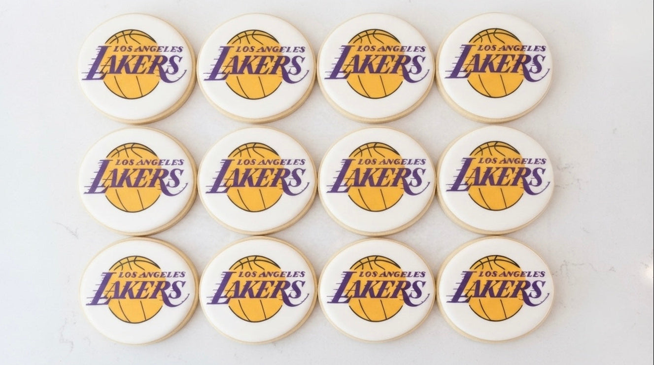 12 handmade Lakers logo cookies decorated with basketball-inspired designs, perfect for Lakers fans, birthdays, game days, and sports celebrations
Lakers logo sugar cookies 12 count for basketball parties and game-day celebrations.
Custom Lakers basketball cookies decorated for birthdays, watch parties, and sports events.
Hand decorated Lakers-themed cookies for basketball fans and party favors.