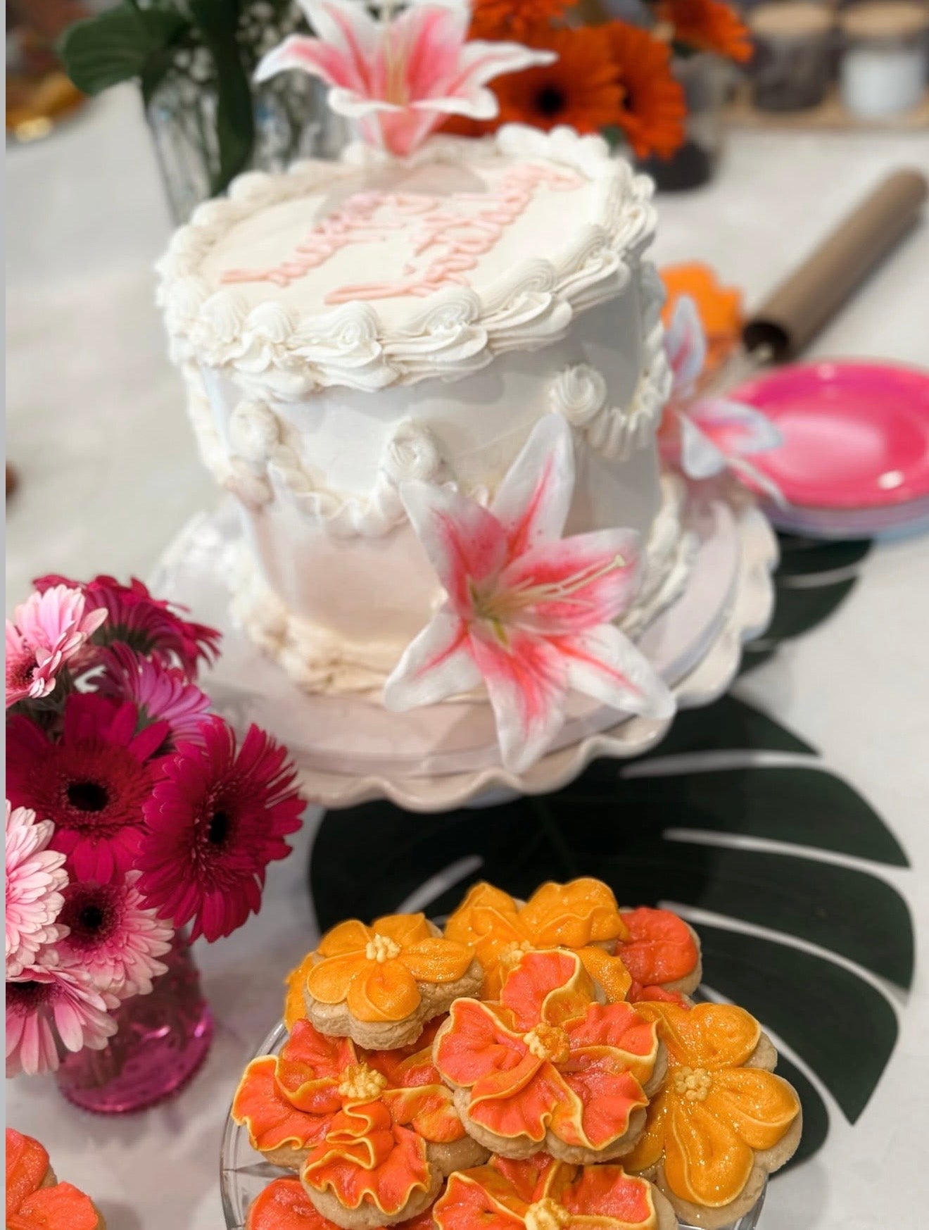 Handcrafted vintage-style birthday cake decorated with intricate buttercream piping, soft pastel accents, and lily details.